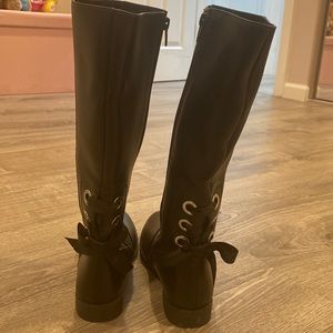Girls black leather boots.